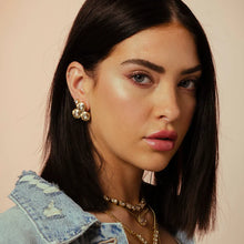 Load image into Gallery viewer, For an enduring glitter, choose the Reya Earrings from Canada! Measuring 1”, these studs with three round premium champagne crystals are crafted with brass base metal, gilded with antique gold. Furthermore, the surgical steel posts keep the earrings securely in place for lasting sparkle. Color- Gold and champagne. Diameter- I inch. Antique gold plating over brass. Premium crystals. Surgical steel posts.