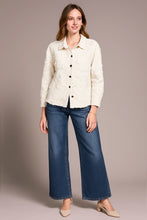 Load image into Gallery viewer, Woman wearing a cream shacket with applique and rhinestone detailing, blue jeans and tan heels against a neutral background.