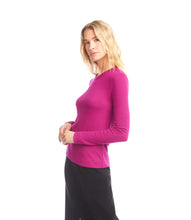 Load image into Gallery viewer, Woman wearing a magenta ribbed long sleeve top and black skirt against a white background.