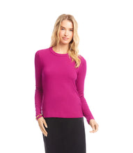 Load image into Gallery viewer, Woman wearing a magenta ribbed long sleeve top and black skirt against a white background.