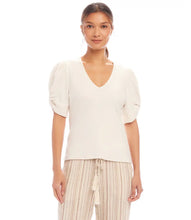 Load image into Gallery viewer, Redefine your wardrobe essentials with the Rayne Ribbed Twist Sleeve V-Neck Top. Crafted from a soft, stretchy cotton ribbed knit, this top hugs your silhouette with effortless charm. The standout twist sleeve design adds a modern touch to the classic V-neck style, making it perfect for layering or wearing solo. Chic, versatile, and timeless—it's a piece you'll reach for again and again.