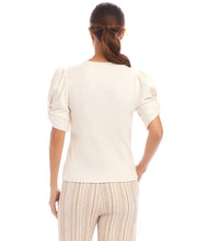 Load image into Gallery viewer, Redefine your wardrobe essentials with the Rayne Ribbed Twist Sleeve V-Neck Top. Crafted from a soft, stretchy cotton ribbed knit, this top hugs your silhouette with effortless charm. The standout twist sleeve design adds a modern touch to the classic V-neck style, making it perfect for layering or wearing solo. Chic, versatile, and timeless—it's a piece you'll reach for again and again.
