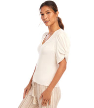 Load image into Gallery viewer, Redefine your wardrobe essentials with the Rayne Ribbed Twist Sleeve V-Neck Top. Crafted from a soft, stretchy cotton ribbed knit, this top hugs your silhouette with effortless charm. The standout twist sleeve design adds a modern touch to the classic V-neck style, making it perfect for layering or wearing solo. Chic, versatile, and timeless—it's a piece you'll reach for again and again.