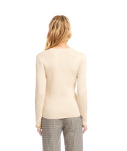 Load image into Gallery viewer, Woman wearing a beige sweater and plaid pants against a white background.