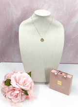 Load image into Gallery viewer, The Rosemary necklace is a stunning piece, featuring a vintage designer button adorned with sparkling rhinestones. Its delicate gold chain adds an extra touch of brilliance. Whether worn alone or layered with other necklaces, this modern piece adds the perfect amount of shine to any outfit, from a simple tee and jeans to a more dressed-up look.