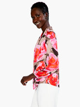Load image into Gallery viewer, This gorgeous and cheery print of the Rosy Outlook top will brighten any day! Made with comfort in mind, this lightweight top features an elastic cuff, flowing long sleeve, and an easy fit. The band collar elevates the look and provides dress up potential. Sits at the hip. Color- Pink multi. Lightweight. Easy fit. Band collar Long sleeve Elastic cuff sleeve Sits at hip
