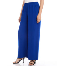 Load image into Gallery viewer, These wide leg pants effortlessly blend style with comfort, thanks to the elasticized waistband providing a flattering and comfortable fit. It's the ideal fusion of fashion and functionality. Color - Royal blue. Full length. Wide-leg. Elasticized waistband. Inseam: 30 inches (size M). Front rise: 13 1/8 inches (size M). Leg Opening: 25 inches (size M). Fabric -Moss Crepe: 100% Polyester.