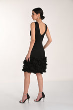 Load image into Gallery viewer, Woman wearing a black dress with ruffled hem and black sparkle heels on a white background.
