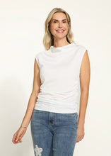 Load image into Gallery viewer, The white FDJ French Dressing Ruched Cap Sleeve Top is the epitome of sleek and stylish casual wear. With its side ruching, it creates a figure-flattering silhouette that adds a touch of elegance to any outfit. The cap sleeves and mock neck design offer a modern and trendy look, making it a perfect addition to your wardrobe. Whether you're dressing up for a special occasion or dressing down for a casual day out, this versatile top is a must-have.