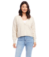 Load image into Gallery viewer, This cardigan sweater features intricate, textured yarns that form a sophisticated cable knit pattern. An ageless piece, it can be dressed up or worn casually for any occasion. Color- Sand. Long sleeve. Button down. Cable knit.