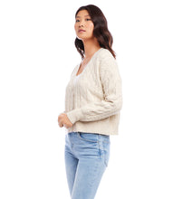 Load image into Gallery viewer, This cardigan sweater features intricate, textured yarns that form a sophisticated cable knit pattern. An ageless piece, it can be dressed up or worn casually for any occasion. Color- Sand. Long sleeve. Button down. Cable knit.