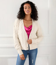 Load image into Gallery viewer, This cardigan sweater features intricate, textured yarns that form a sophisticated cable knit pattern. An ageless piece, it can be dressed up or worn casually for any occasion. Color- Sand. Long sleeve. Button down. Cable knit.