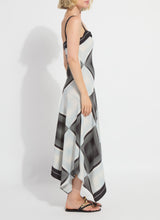 Load image into Gallery viewer, Woman wearing a black and white patterned dress and black sandals on a white background.
