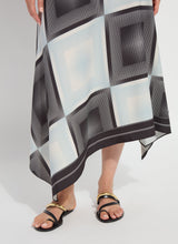 Load image into Gallery viewer, Model wearing a black and white patterned dress and black sandals on a white background.