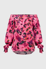 Load image into Gallery viewer, Elevate your ensemble with this stunning satin top, adorned with captivating print. The off-shoulder neckline exudes allure, while the gathered statement sleeves add a touch of sophistication. Designed in a relaxed with a high-low hem, it offers an effortlessly chic appeal. This is part of Joseph Ribkoff's Signature collection.
