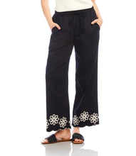 Load image into Gallery viewer, Refined yet effortlessly comfortable, the Sherrit Scallop Drawstring Pants by Karen Kane blend elegance with everyday ease. Crafted from black cotton woven fabric, these wide-leg pants feature delicate cream embroidery and a scalloped hem. Perfect for casual outings, workdays, or evening wear, these versatile embroidered pants pair beautifully with blouses, tanks, or structured tops.