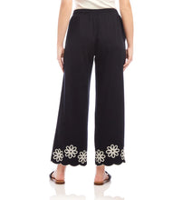 Load image into Gallery viewer, Refined yet effortlessly comfortable, the Sherrit Scallop Drawstring Pants by Karen Kane blend elegance with everyday ease. Crafted from black cotton woven fabric, these wide-leg pants feature delicate cream embroidery and a scalloped hem. Perfect for casual outings, workdays, or evening wear, these versatile embroidered pants pair beautifully with blouses, tanks, or structured tops.