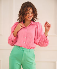 Load image into Gallery viewer, This fabulous blouse in a striking pink is made of soft seersucker quality; a light summery fabric that is slightly puckered. Our Pennie top has a collar, billowy long sleeves with a wide cuff that allows you to add extra puff to the sleeves. The top has a wider, flowy fit and looks stunning paired with white bottoms or our FALLON FLAIR JEAN IN JADE COLOR- ESQUALO. Color- Pink. Button down. Long sleeve.