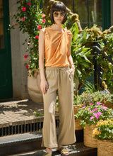 Load image into Gallery viewer, Add a touch of modern style with the Selene Twisted Shoulder Top in vibrant Solar Ray by Lysse. Featuring a unique twisted shoulder detail, this top combines comfort with chic sophistication. The soft, breathable fabric ensures all-day wearability, while the relaxed fit makes it perfect for casual, work, or evening outfits.