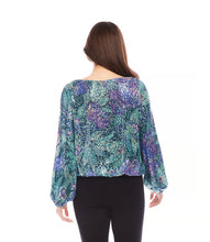 Load image into Gallery viewer, Enhance your wardrobe with our boatneck top, radiating bold sophistication. It features a vibrant floral print adorned with sparkling sequins, made from luxurious Italian fabric. This top complements a variety of bottoms, including your go-to denim. Stand out in style with this exquisite piece.