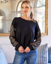 Load image into Gallery viewer, Constructed from a luxuriously soft fabric blend, this top, in a sweatshirt fabrication, is ideal for any type of event, from casual to formal. It pairs beautifully with both denim and skirts and boasts a crew neckline and long sleeves adorned with sequins for a subtle touch of shimmer.