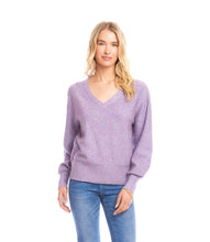 Load image into Gallery viewer, Woman wearing a purple sequin sweater and blue jeans against a white background.