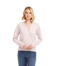 Load image into Gallery viewer, Woman wearing a light pink sweater and blue jeans against a white background.