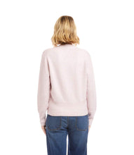 Load image into Gallery viewer, Woman wearing a light pink sweater and blue jeans against a white background.