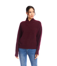 Load image into Gallery viewer, Woman wearing a burgundy sweater and blue jeans against a white background.