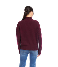 Load image into Gallery viewer, Woman wearing a burgundy sweater and blue jeans against a white background.