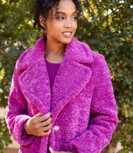 Load image into Gallery viewer, Woman wearing a bright orchid coat standing in front of a green tree.