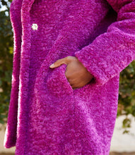 Load image into Gallery viewer, Close-up of a model wearing a bright orchid coat with a blurred natural background.