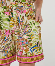Load image into Gallery viewer, Colorful patterned shorts against a neutral background.