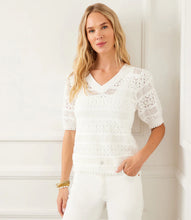 Load image into Gallery viewer, Woman wearing an off-white, short sleeve crochet top against a white background.