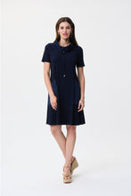 Load image into Gallery viewer, Step into timeless elegance with the Joseph Ribkoff Midnight Blue Dress—a must-have for effortless sophistication. Crafted from a luxurious stretchy fabric, this knee-length A-line dress offers a comfortable fit with front pockets and a stylish cowl-neck and drawstring detail. Perfect for casual outings or elevated occasions, its polyester-spandex blend ensures a flattering silhouette while keeping you comfortable all day long.