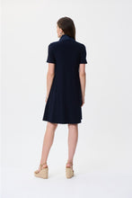 Load image into Gallery viewer, Step into timeless elegance with the Joseph Ribkoff Midnight Blue Dress—a must-have for effortless sophistication. Crafted from a luxurious stretchy fabric, this knee-length A-line dress offers a comfortable fit with front pockets and a stylish cowl-neck and drawstring detail. Perfect for casual outings or elevated occasions, its polyester-spandex blend ensures a flattering silhouette while keeping you comfortable all day long.