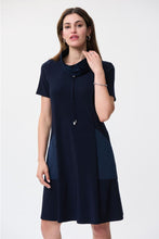 Load image into Gallery viewer, Step into timeless elegance with the Joseph Ribkoff Midnight Blue Dress—a must-have for effortless sophistication. Crafted from a luxurious stretchy fabric, this knee-length A-line dress offers a comfortable fit with front pockets and a stylish cowl-neck and drawstring detail. Perfect for casual outings or elevated occasions, its polyester-spandex blend ensures a flattering silhouette while keeping you comfortable all day long.
