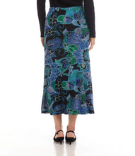 Load image into Gallery viewer, Model wearing a blue, green, purple multi-print midi skirt, black top and black short -heeled sandals against a white background.