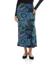 Load image into Gallery viewer, Model wearing a blue, green, purple multi-print midi skirt, black top and black short -heeled sandals against a white background.