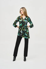 Load image into Gallery viewer, Elegance and comfort blend harmoniously in this beautiful silky knit tunic. Boasting a bold abstract print, the garment is tailored with chic three-quarter sleeves and an airy asymmetrical silhouette that creates an alluring look. The V-shaped neckline with zipper closure infuses modern flair into this classic design.