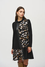 Load image into Gallery viewer, Experience contemporary sophistication with this luxurious silky knit dress. Its captivating animal print, elegant cowl neckline, and three-quarter sleeves radiate a sense of effortless chic. The dress is further enhanced by sleek sweater knit inserts and leatherette accents, while the A-line cut gracefully defines the silhouette.
