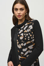 Load image into Gallery viewer, Experience contemporary sophistication with this luxurious silky knit dress. Its captivating animal print, elegant cowl neckline, and three-quarter sleeves radiate a sense of effortless chic. The dress is further enhanced by sleek sweater knit inserts and leatherette accents, while the A-line cut gracefully defines the silhouette.