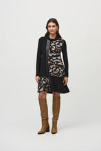 Load image into Gallery viewer, Experience contemporary sophistication with this luxurious silky knit dress. Its captivating animal print, elegant cowl neckline, and three-quarter sleeves radiate a sense of effortless chic. The dress is further enhanced by sleek sweater knit inserts and leatherette accents, while the A-line cut gracefully defines the silhouette.