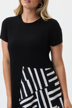 Load image into Gallery viewer, If you are looking for a comfortable and highly fashionable dress, our Soren knit woven dress is a beautiful addition to your wardrobe. A one piece, pullover dress, our Soren is a solid black on top and down one side of the dress, while the other half of its skirting is voluminous with a ruffled abstract pattern hem. This flowy dress feels as gorgeous as it looks! Color- Black and white. One piece dress. Abstract print on one side. Solid on the other. Solid color top. Ruffled hem on one side. No pockets.