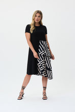 Load image into Gallery viewer, If you are looking for a comfortable and highly fashionable dress, our Soren knit woven dress is a beautiful addition to your wardrobe. A one piece, pullover dress, our Soren is a solid black on top and down one side of the dress, while the other half of its skirting is voluminous with a ruffled abstract pattern hem. This flowy dress feels as gorgeous as it looks! Color- Black and white. One piece dress. Abstract print on one side. Solid on the other. Solid color top. Ruffled hem on one side. No pockets.