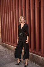 Load image into Gallery viewer, Boost your confidence in every stride with this stunning silky knit wrap jumpsuit. Designed with an overlapping culotte leg and elegant three-quarter sleeves, this garment exudes feminine grace and sophistication. Accentuate your figure with the waistline sash and sleek wrap neckline, while the delicate waist ornament adds a touch of unique charm.