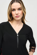Load image into Gallery viewer, Experience ultimate comfort with this soft knit tunic featuring a stunning abstract striped burnout design. The high-low cut highlights the flared shape, while cuffed three-quarter sleeves add a polished touch. A zippered neckline adds a subtle yet eye-catching element, elevating the refined look of this tunic.