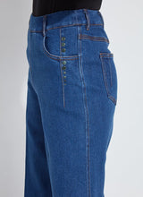 Load image into Gallery viewer, Person wearing blue wide-leg trouser jean and black tee against a white background. Focus on stud detailing on side.