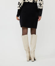 Load image into Gallery viewer, Elevate your style with our Knitted Short Skirt. This versatile piece features a cozy knitted texture and includes shiny gold buttons, making it perfect for both casual and dressy occasions. The skirt's short length and snug fit accentuate your silhouette, while the elastic waistband provides comfort and ease of movement. Pair it with a tucked-in blouse or a cozy sweater for a chic, effortlessly stylish look.