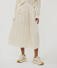 Load image into Gallery viewer, Designed for both elegance and ease, this pleated skirt features a stunning luminous, sheen finish and a comfortable elastic waistband, making it a go-to piece for various occasions. Made with durable polyester and lined with soft viscose, it offers a perfect combination of fashion and practicality. Pair it with heels for a night out or flats for a relaxed yet chic look.